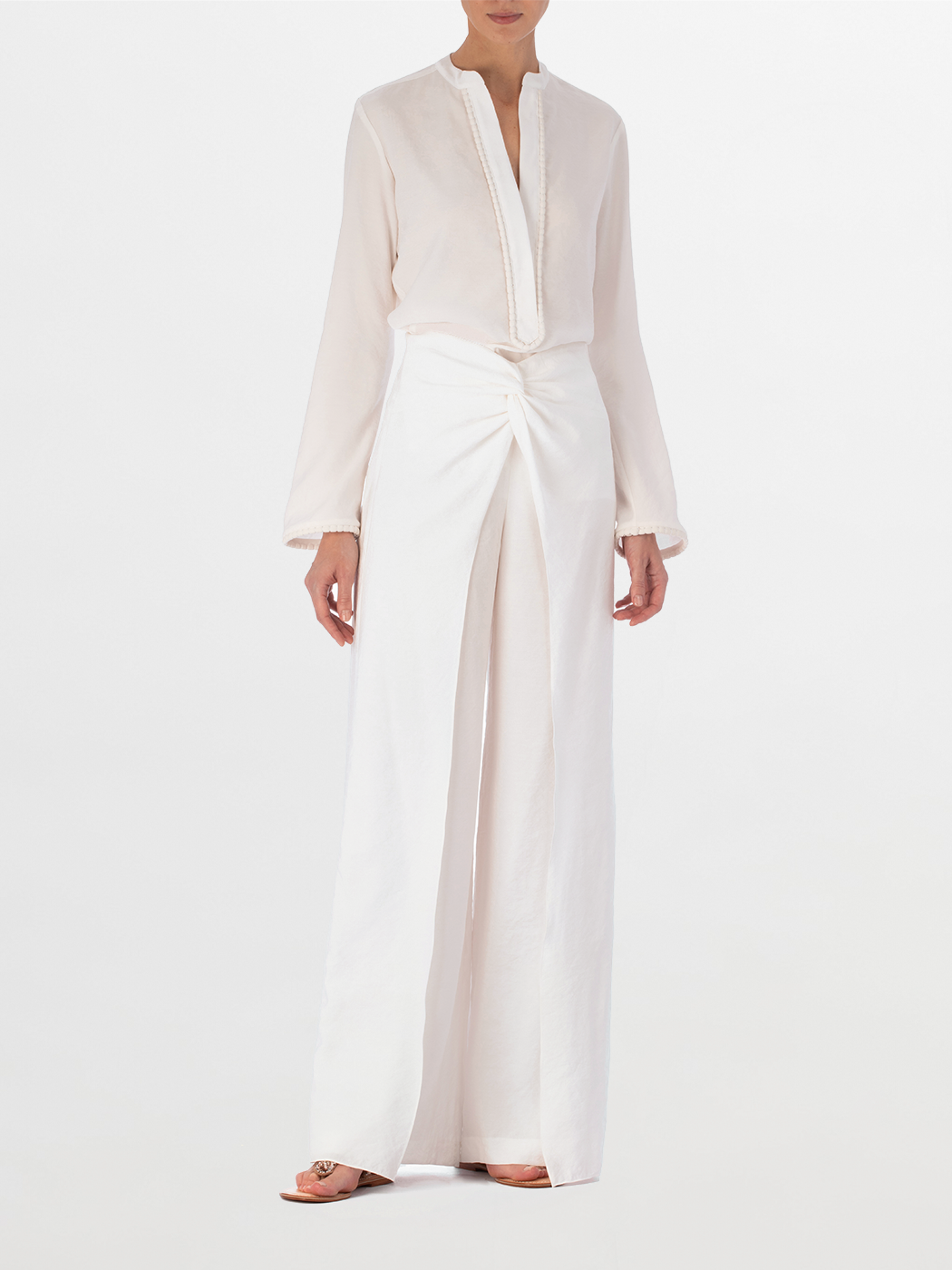 Shera Blouse White with a v-neckline and long sleeves, displayed on a plain background.