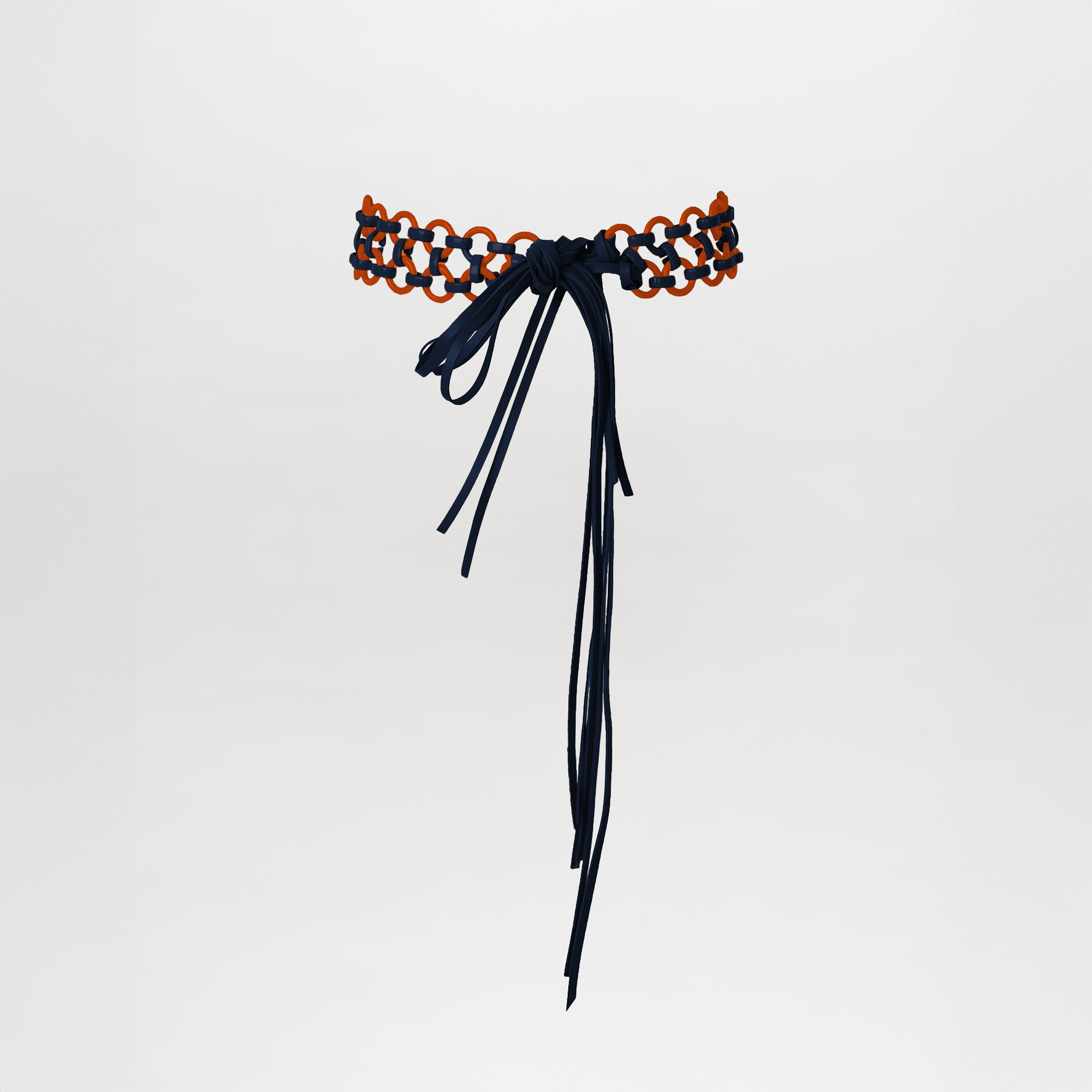 The Sindione Belt Navy/Orange features navy and orange interlocked loops with multi-layer leather straps, finished with a long navy bow and trailing ends, displayed on a plain white background.