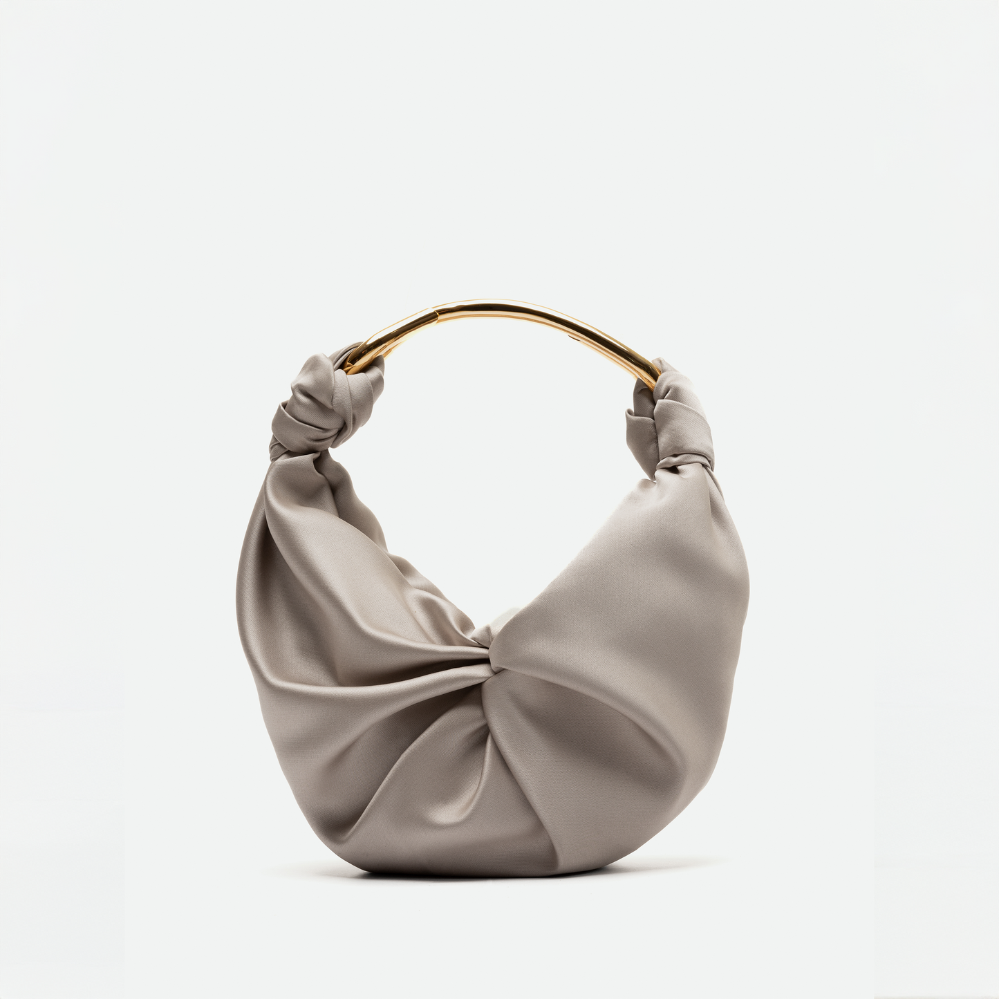 A beige satin handbag with a soft, ruched design and a gold metal handle. This elegant piece is available for pre-order and will ship between November 15 and December 15. The background is plain white.

Replace "beige satin handbag" with "Sofia Bag (Small) Beige":
The Sofia Bag (Small) Beige with a soft, ruched design and a gold metal handle. This elegant piece is available for pre-order and will ship between November 15 and December 15. The background is plain white.