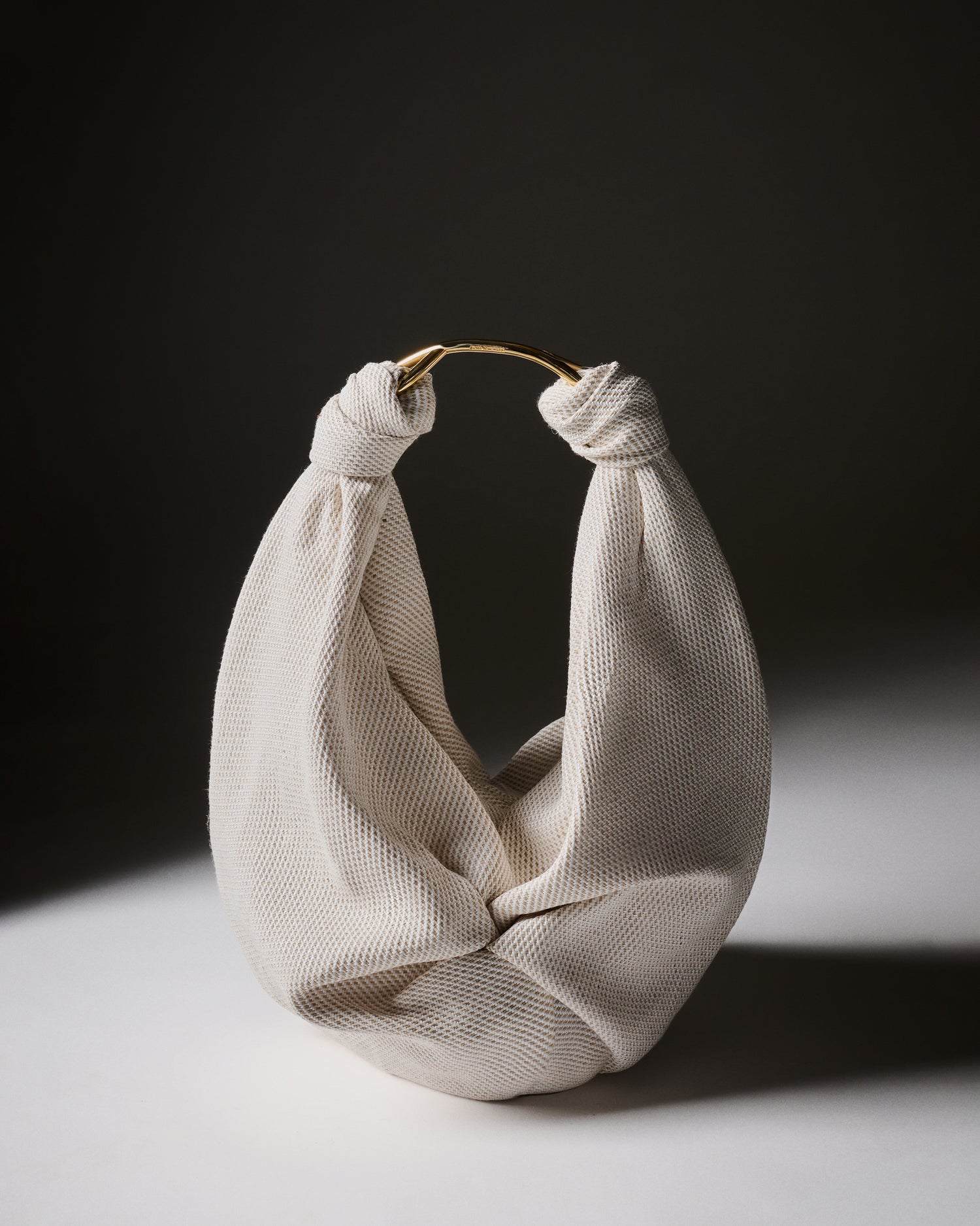 Beige woven bag on a dark background