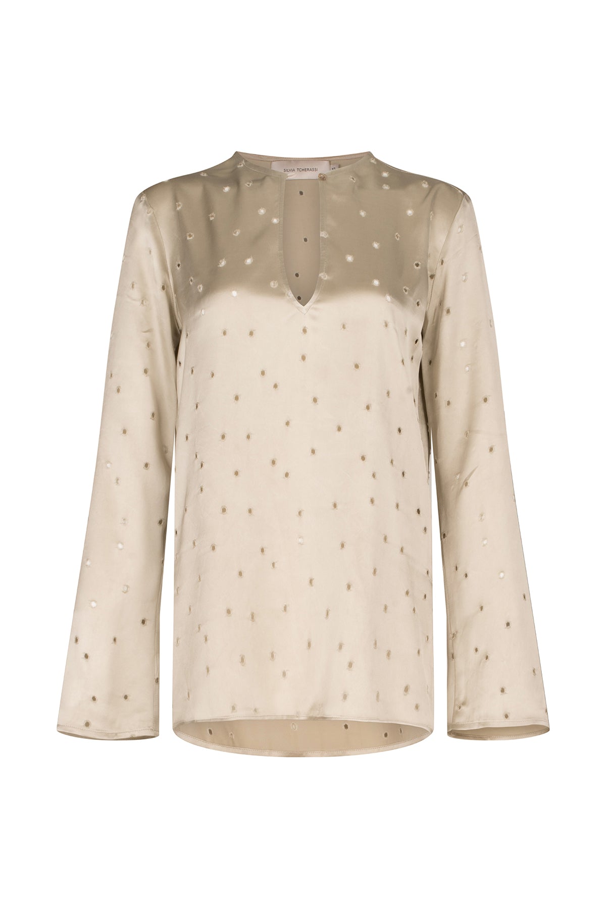 A Tosca Blouse Ecru with a keyhole neckline and gold stars on the fabric texture.