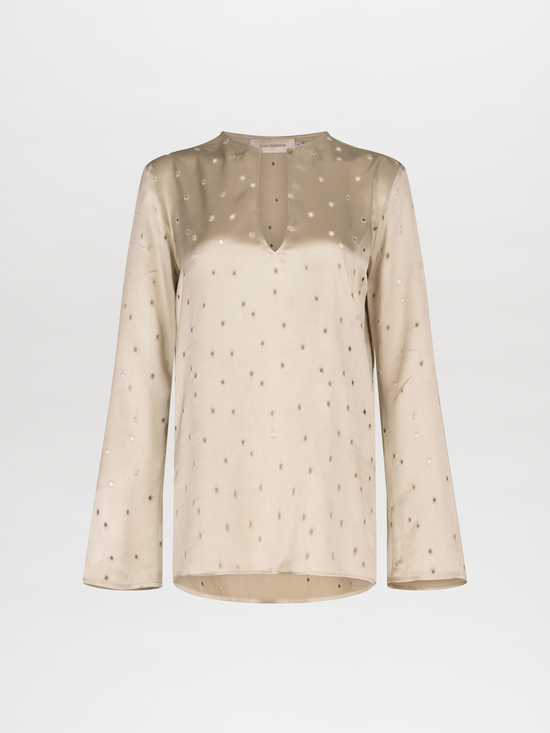 A Tosca Blouse Ecru with a keyhole neckline and gold stars on the fabric texture.