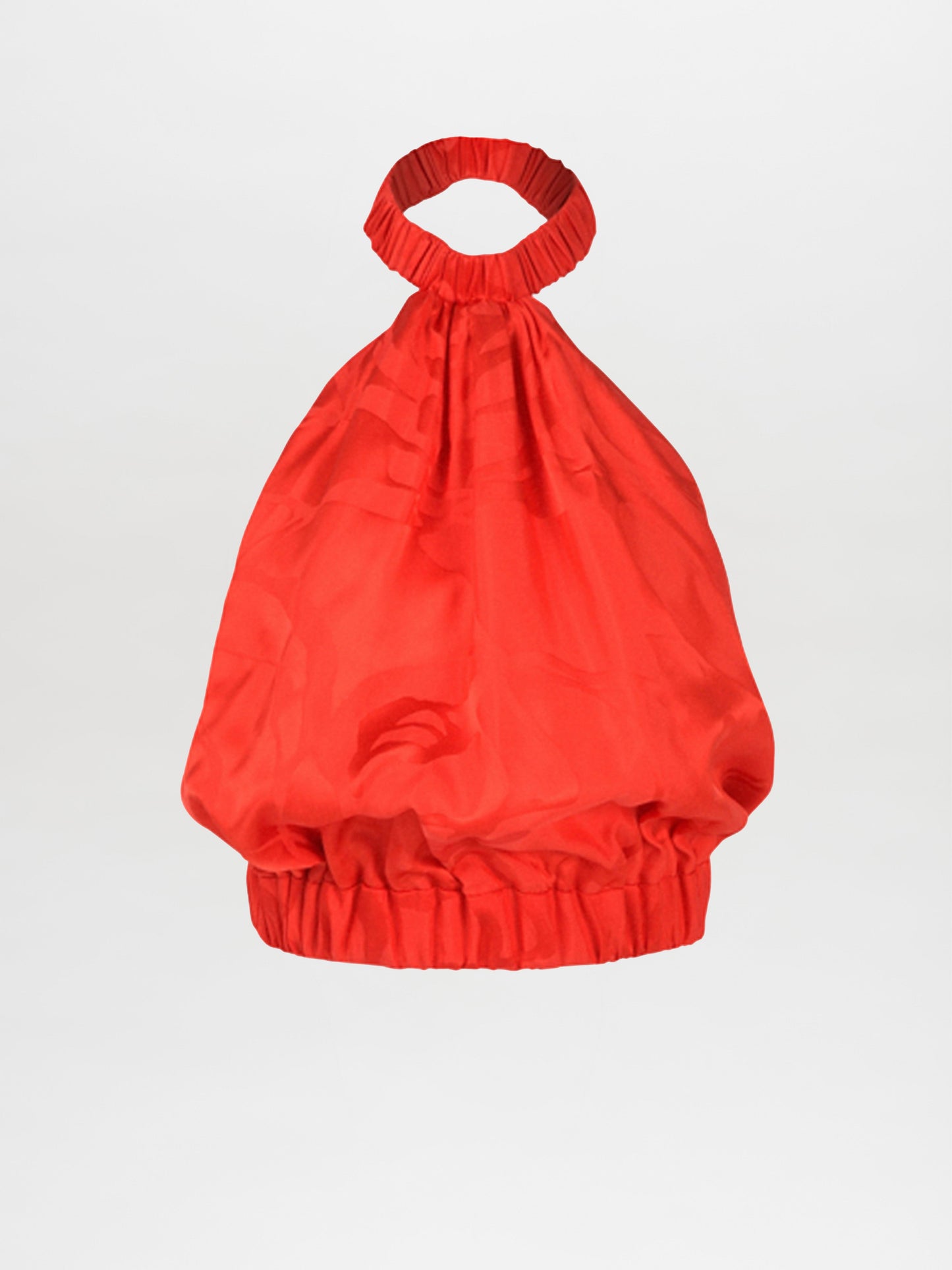 A bright red handbag with ruched fabric, featuring a rounded, gathered top handle and an elasticized opening at the top and bottom, reminiscent of the Tammy Blouse Crimson Jacquard.