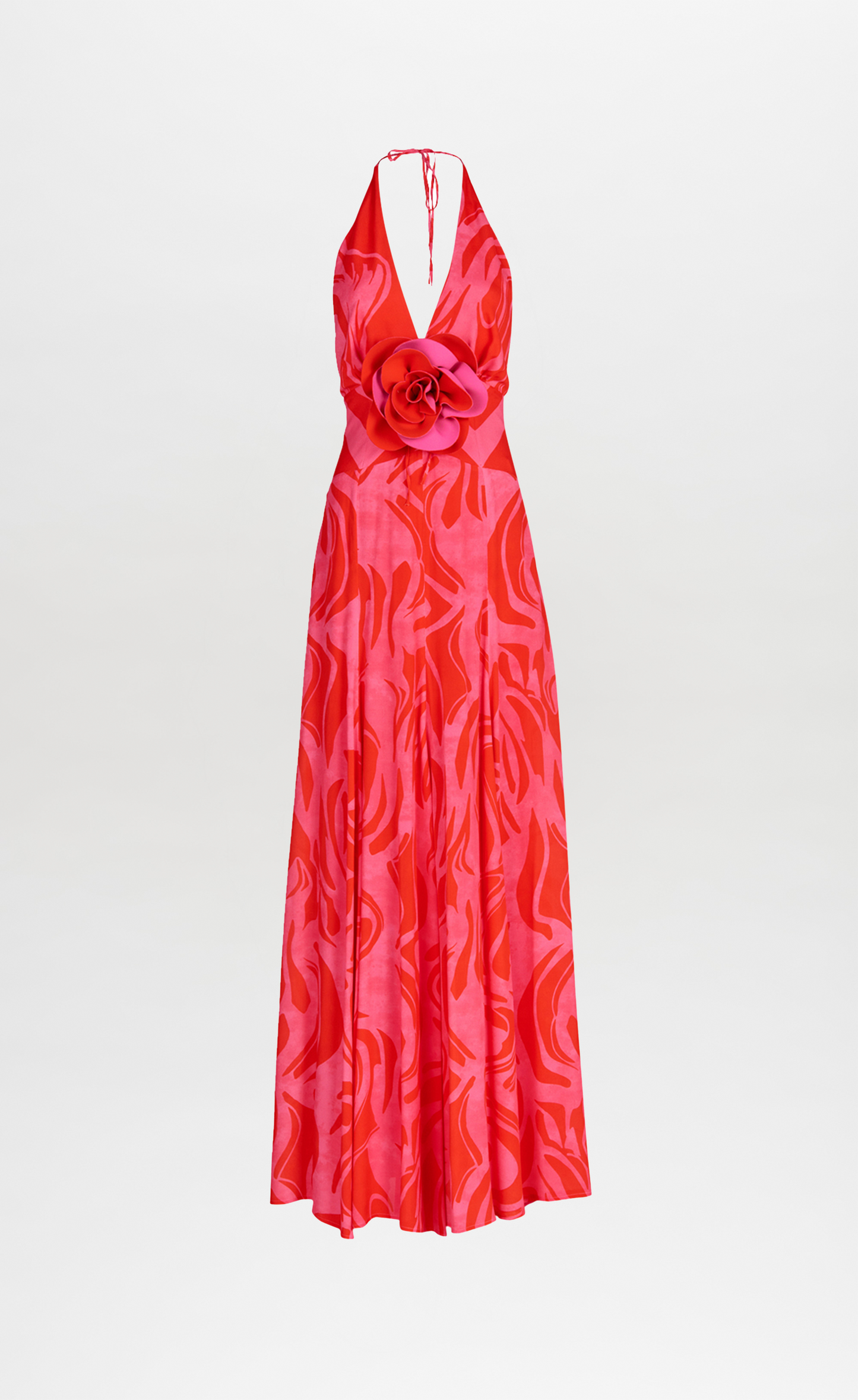 A floor-length Tawny Dress Pink Red Marble with a halt neckline in an abstract floral pattern.