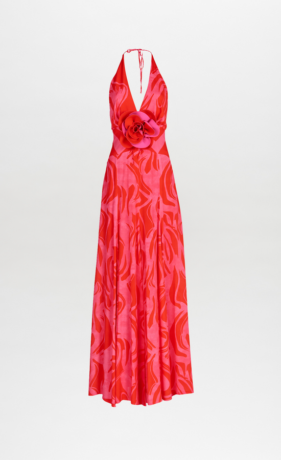 A floor-length Tawny Dress Pink Red Marble with a halt neckline in an abstract floral pattern.