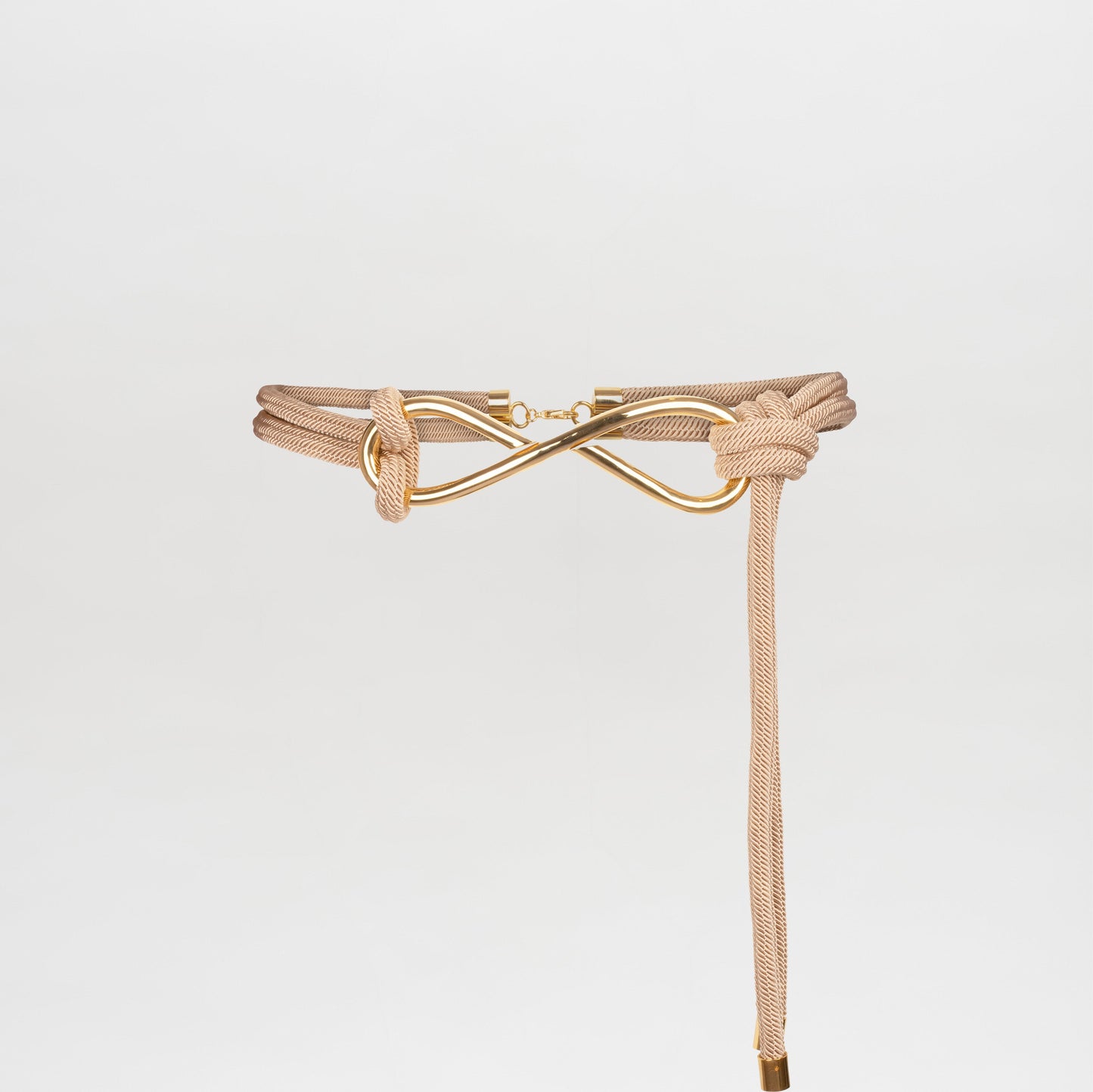 A Tirza Belt Beige with a knot and gold-tone clasp detail, photographed against a plain white background. Pre-order now to ensure you receive yours when we ship on November 15, 2024.