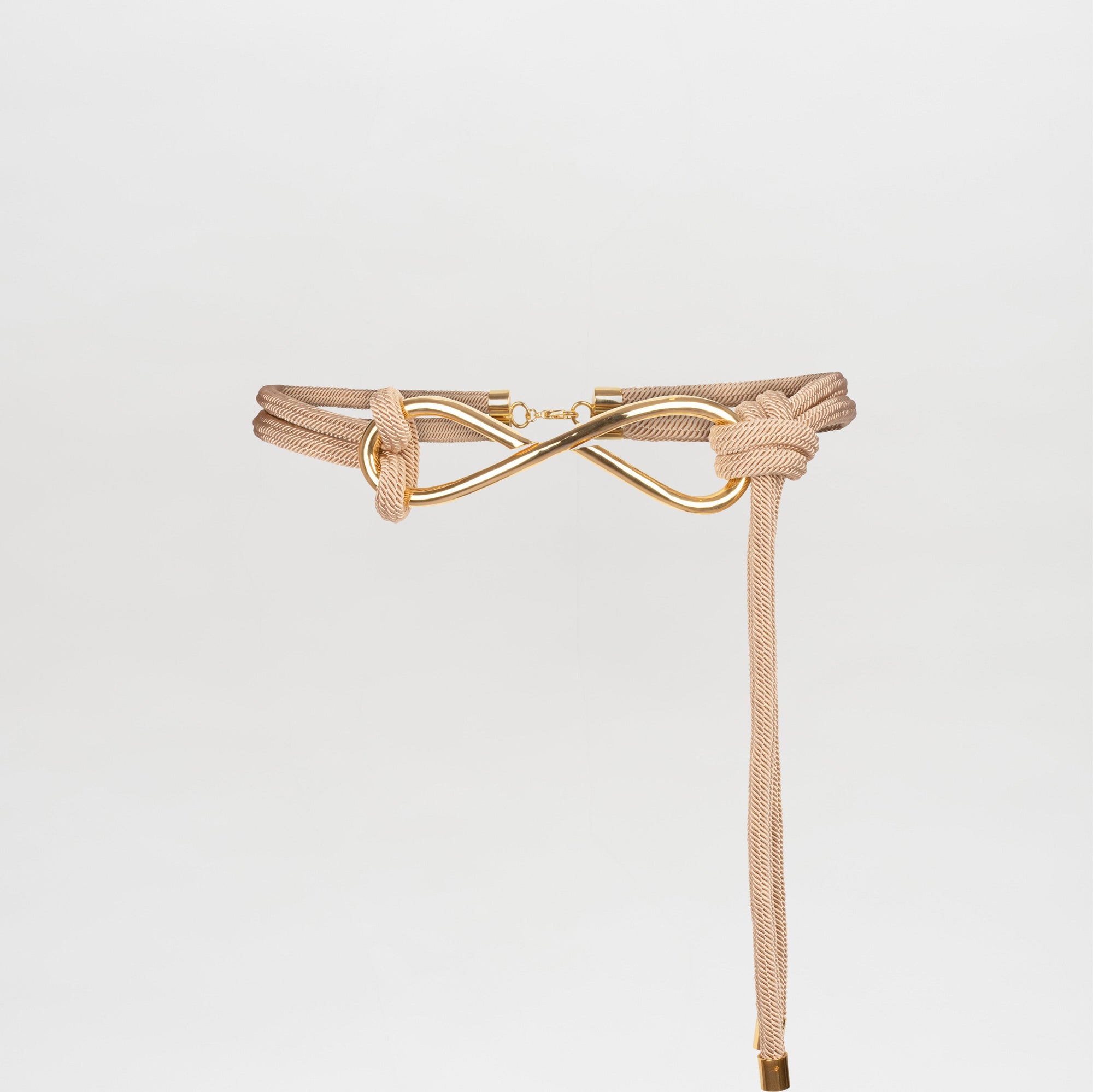 A Tirza Belt Beige with a knot and gold-tone clasp detail, photographed against a plain white background. Pre-order now to ensure you receive yours when we ship on November 15, 2024.