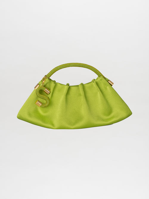 Introducing the Trapezius Clutch Lime: a pleated clutch crafted from crepe fabric, showcasing a vibrant green color and an organic, unique shape with a curved handle. It is elegantly adorned with gold accents and features a stylish S-shaped charm.