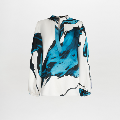 A white Triora Blouse Multi Abstract Waves with bold blue and black abstract print, featuring long sleeves and a V neckline with a tie.