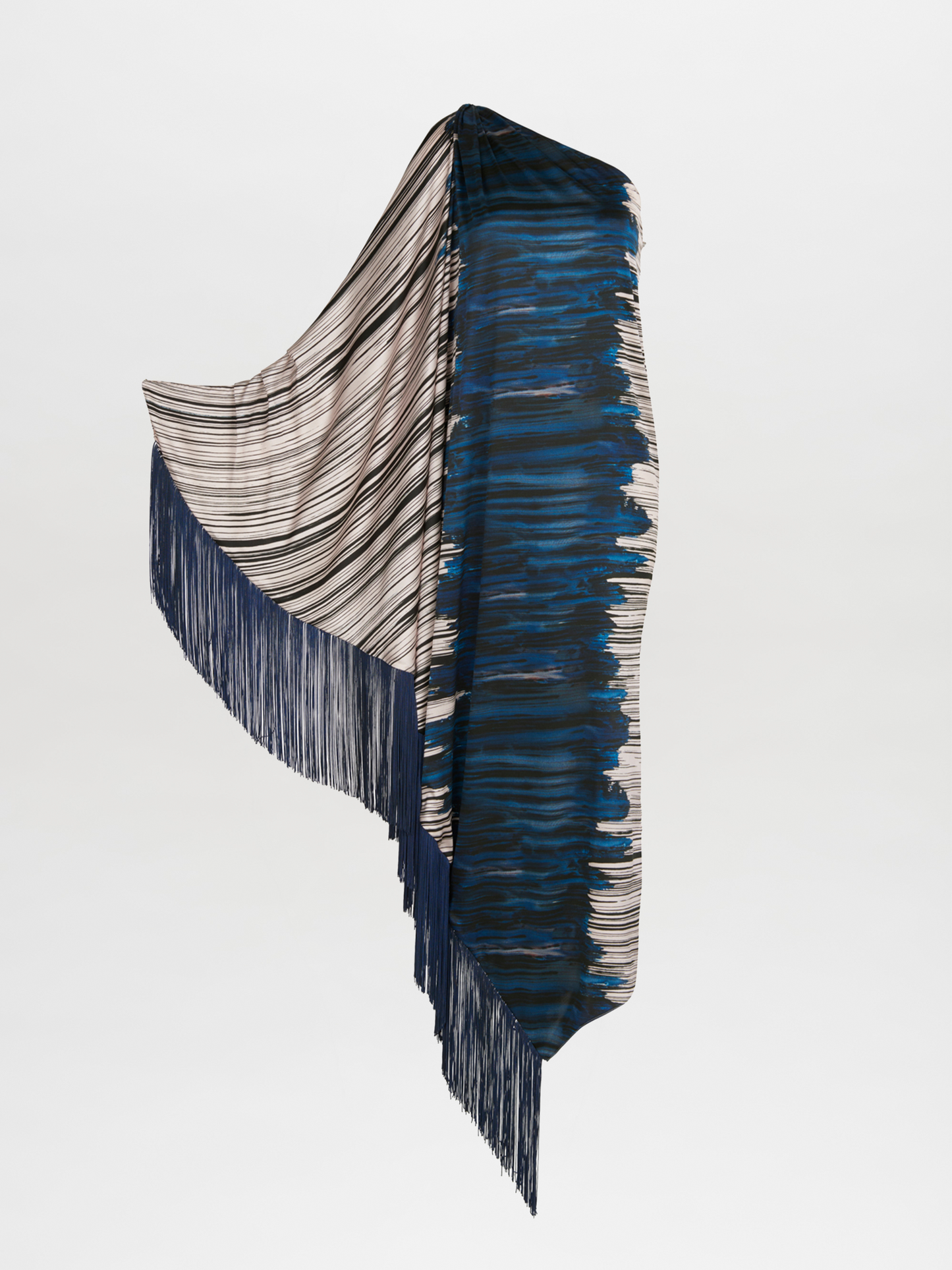 A blue and white fringed Alana Dress Indigo Linear, part of the Fall 2023 collection, is displayed on a mannequin with navy-blue fringes.