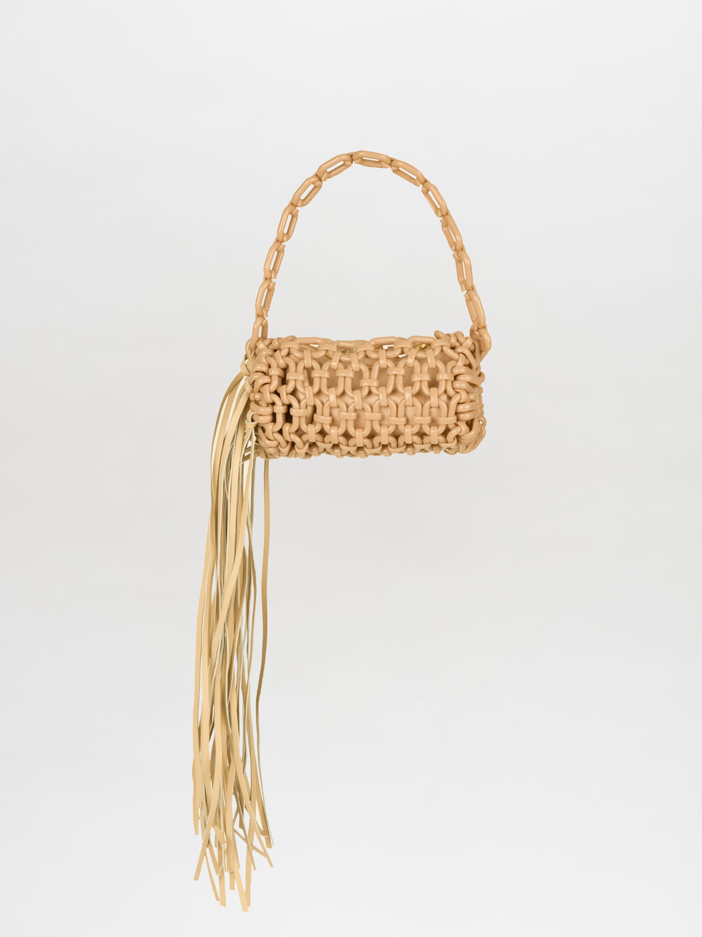 The Vinessa Handbag Ivory showcases a beige woven design with a chain handle and long fringe on one side, perfectly combining elegance with contemporary style.