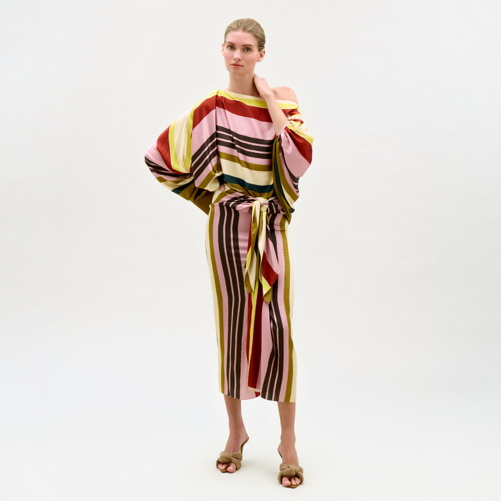 Woman wearing a colorful striped outfit on a white background