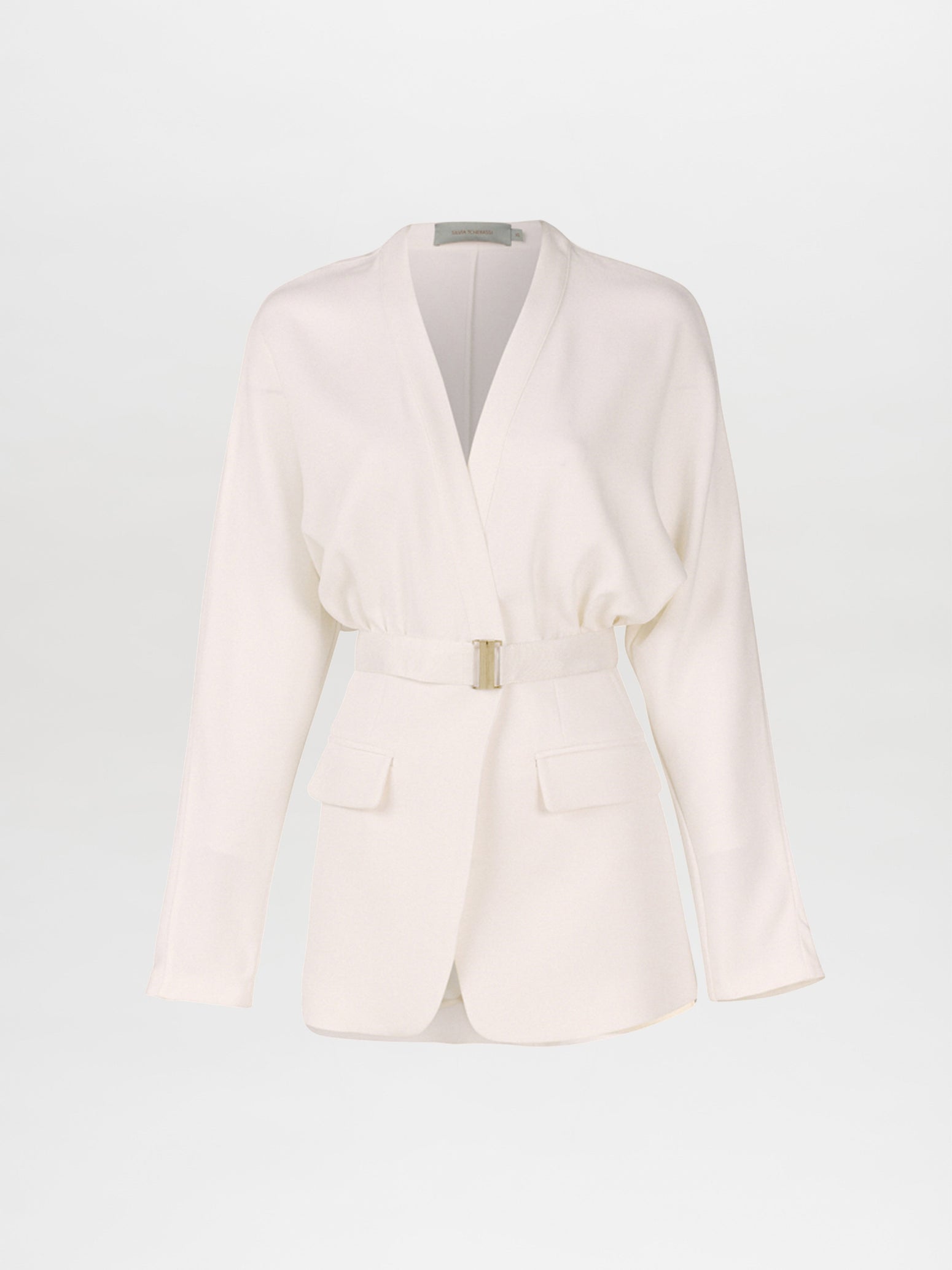 A white belted blazer with long sleeves, two front pockets, and a V-neck collar photographed against a plain background exudes modern elegance. This seasonless sleek white viscose piece, known as the Vogogna Jacket White, is a timeless addition to any wardrobe.