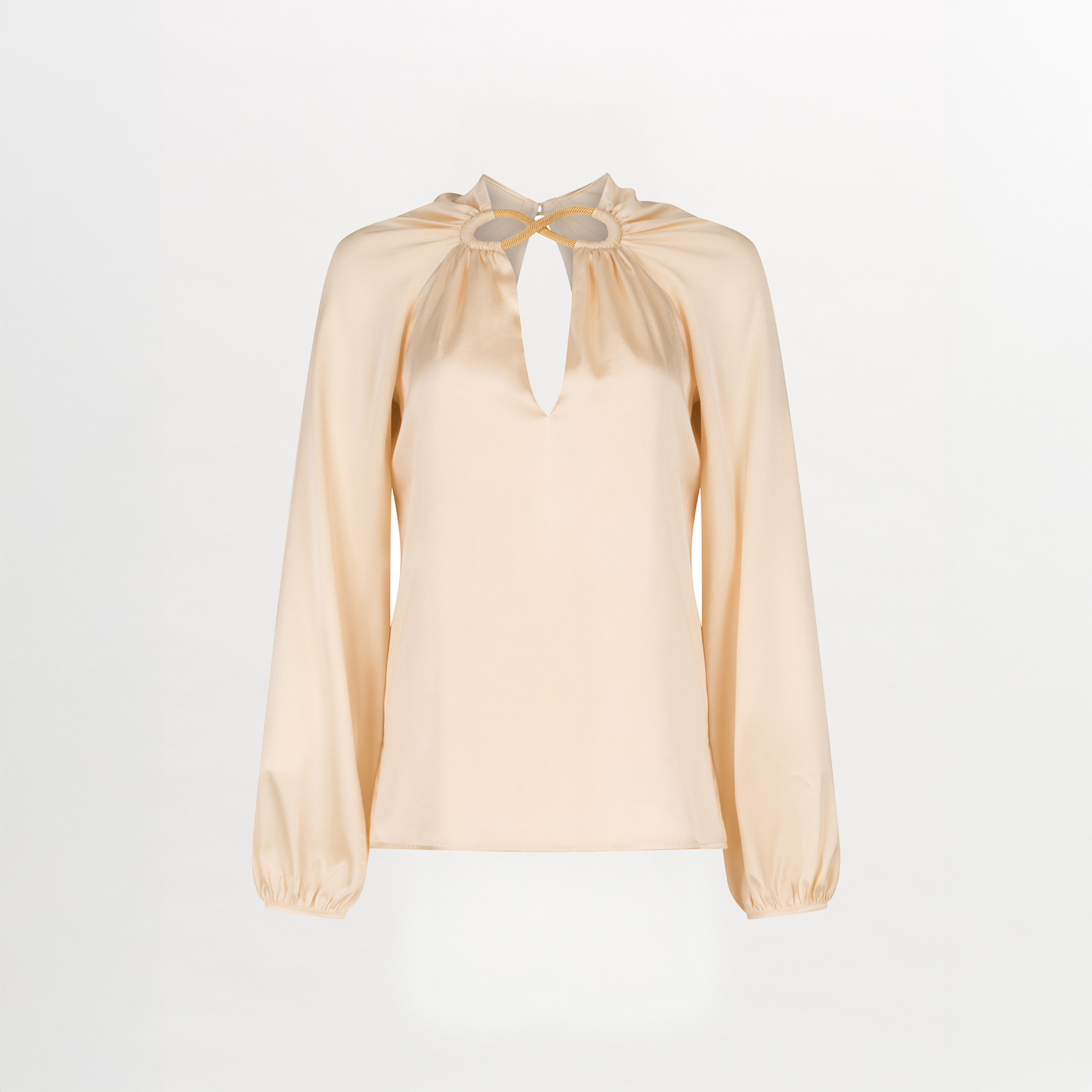 A Ximena Blouse Beige with a ruffled neckline and metallic detailing.