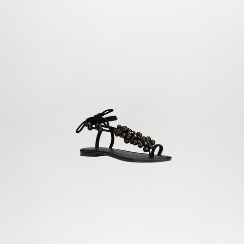 Zaira Sandals featuring black leather with embellished ankle straps and ties, displayed on a plain white background.