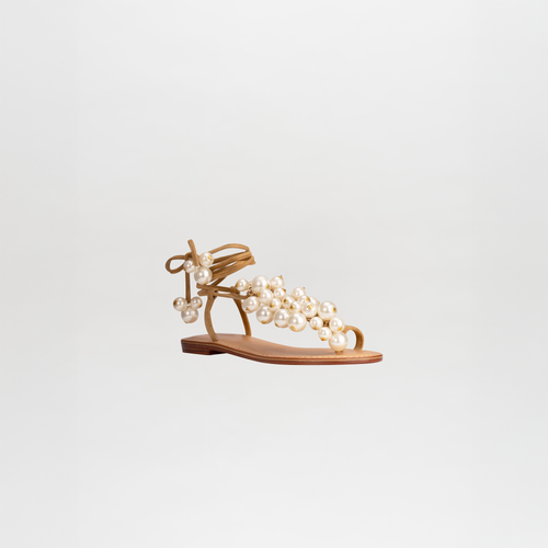 Presenting the Zaira Sandals Camel: a single tan sandal with a flat sole, adorned with multiple pearl-like beads and an ankle tie strap, displayed on a white background. Now available for pre-order; secure yours today and enjoy exclusive shipping by February 15th, 2025.