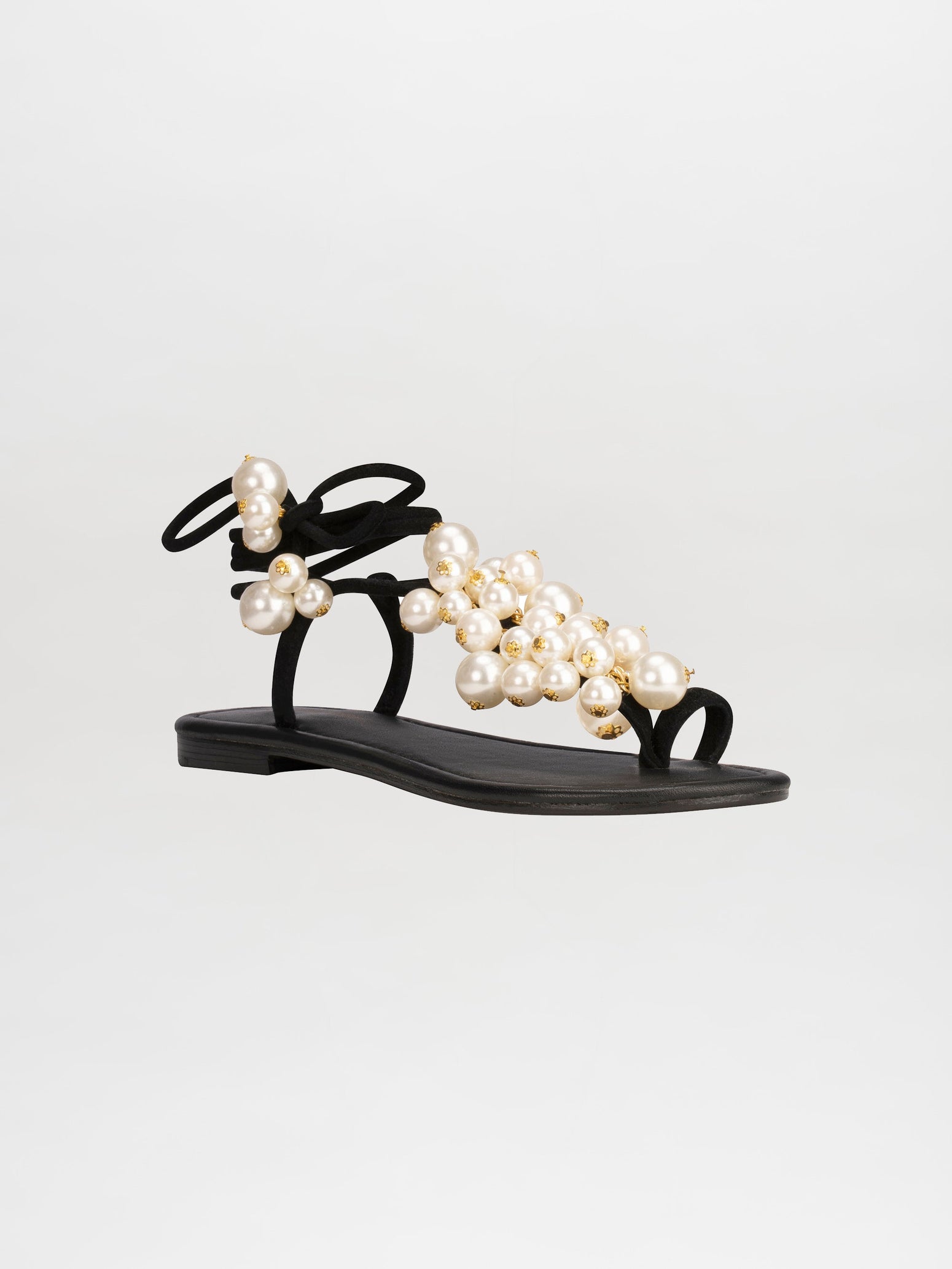 Pre-order the Zaira Sandals Black - Pearl, adorned with clusters of faux pearls and featuring a thin ankle strap with bow details, to ensure you receive them by the ship date of February 15th, 2025.