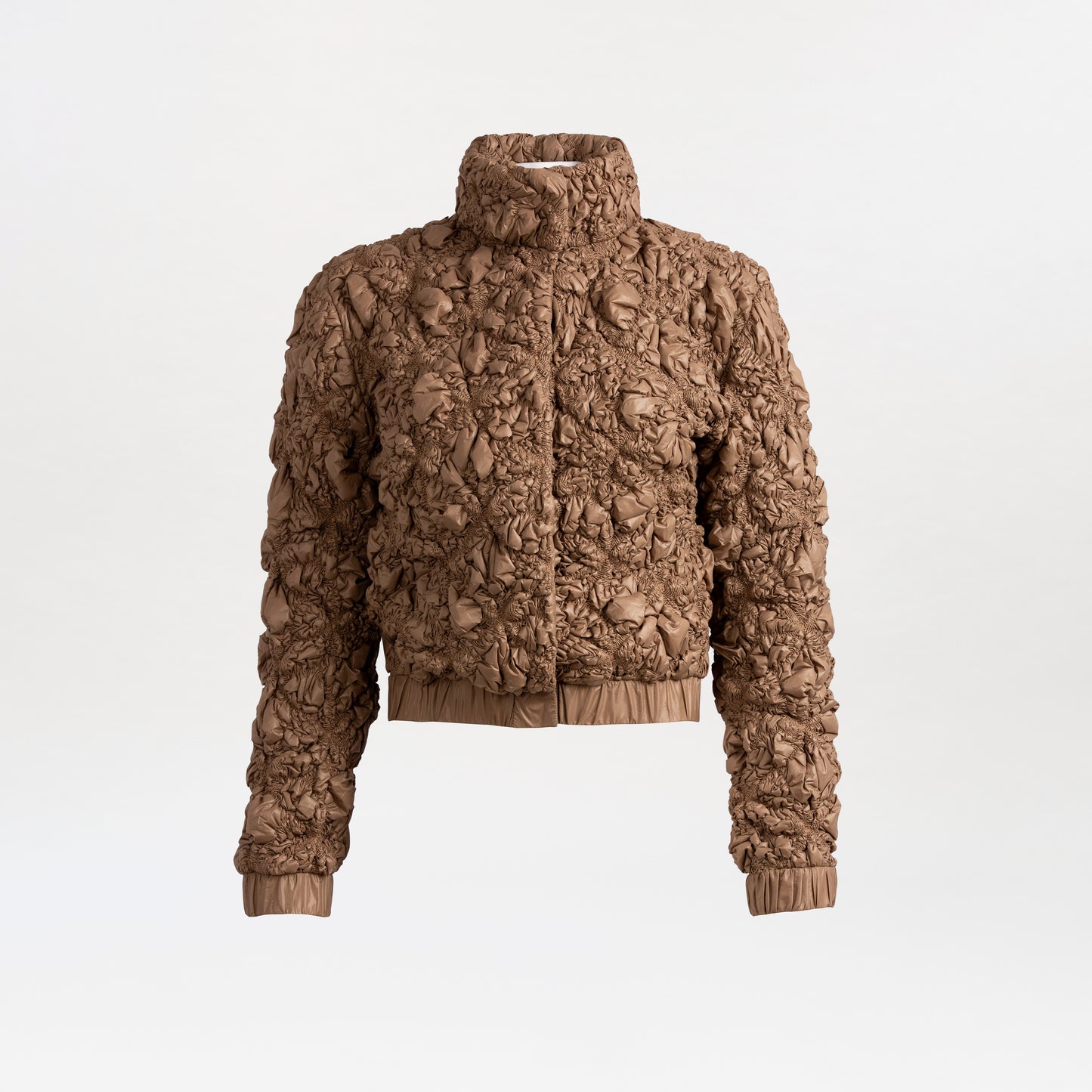The Zalta Jacket is a brown, textured cropped piece with a high collar, crinkled ruched Italian fabric, long sleeves, and elastic cuffs and hem, shown against a plain white background.