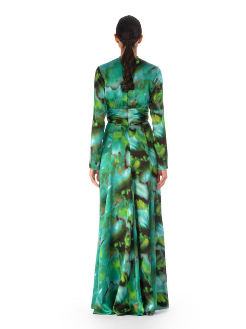 A Zarina Dress Juniper Green featuring a vibrant green and blue floral pattern and a circular belt buckle at the waist, displayed against a white background.