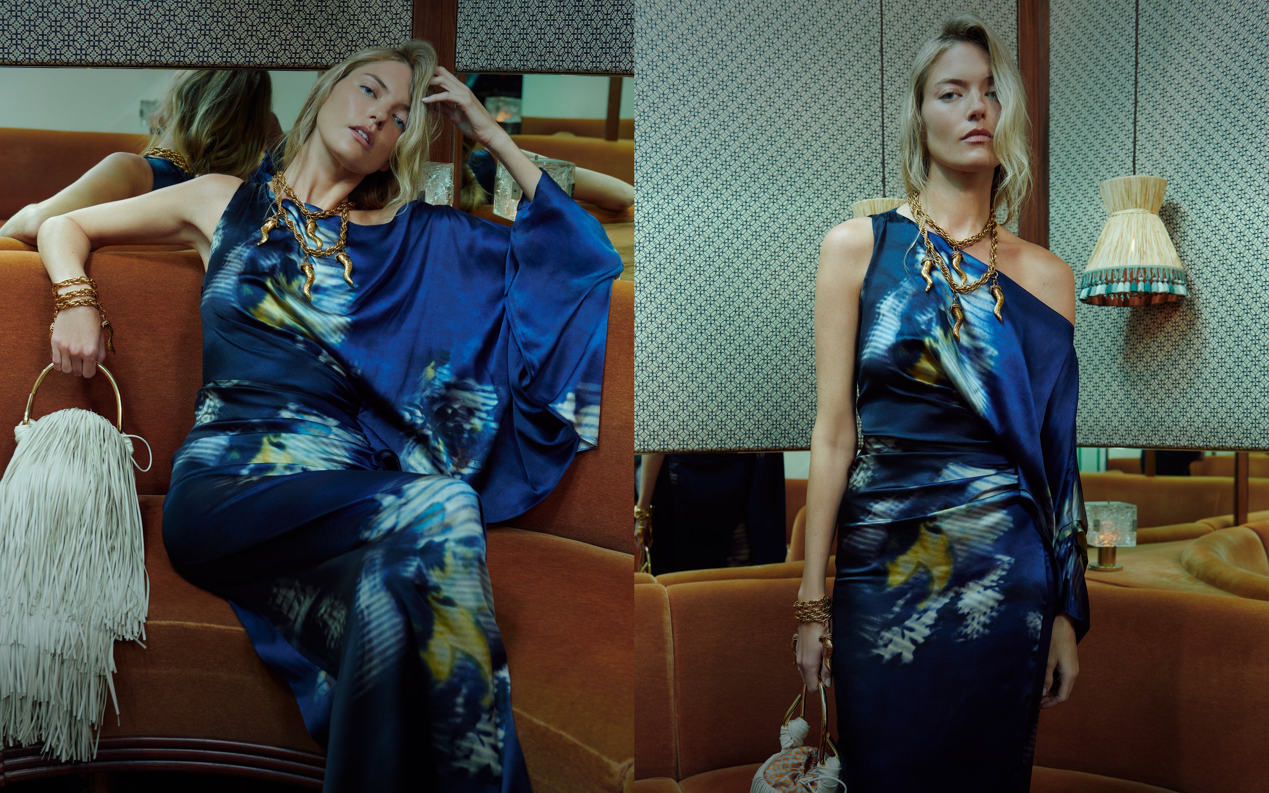 Woman in a blue floral dress sitting on an orange couch with a lamp and chair in the background.