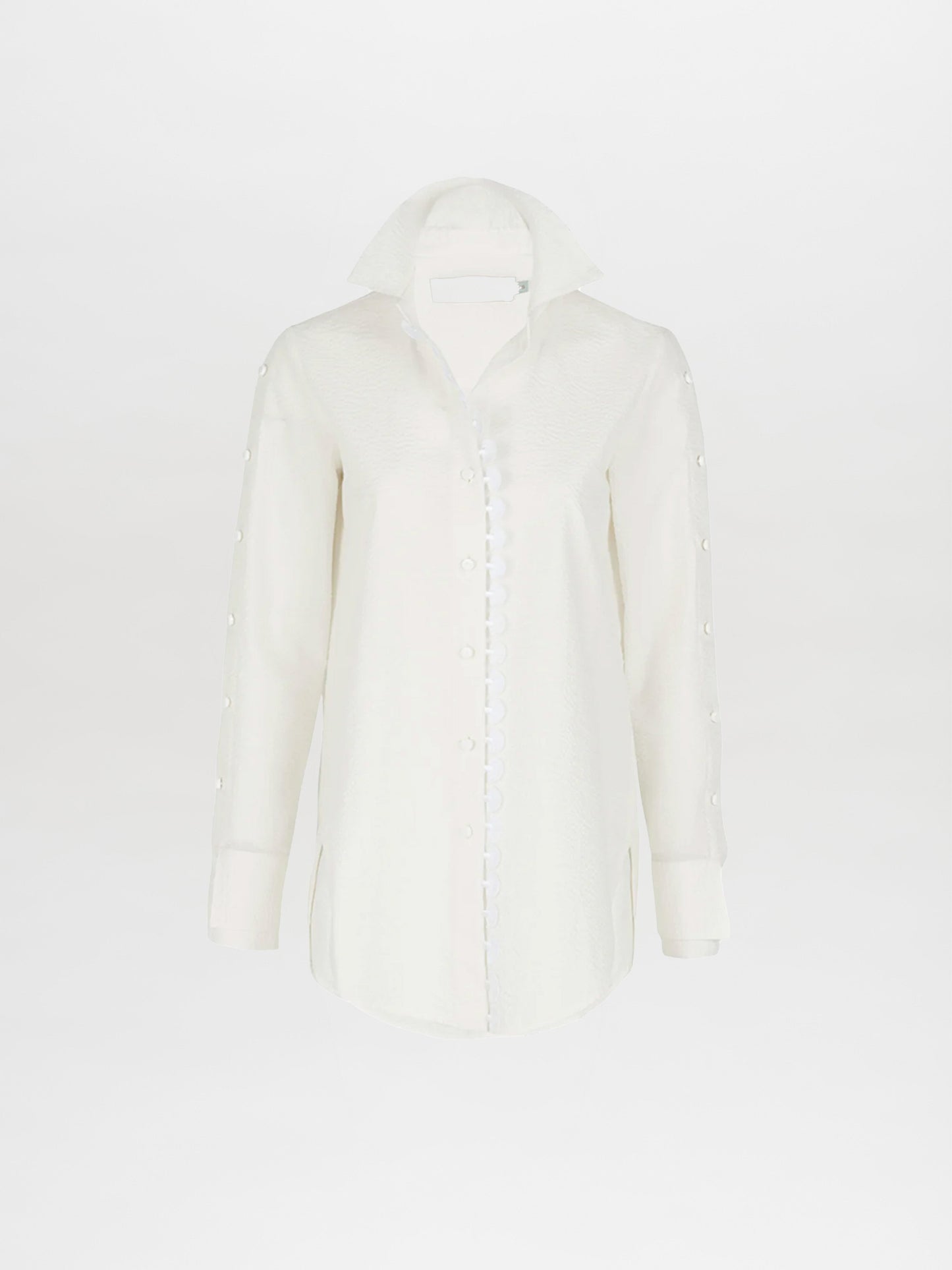 A Premium Blouse White with ruffles on the collar and cuffs, perfect for Spring 2023.