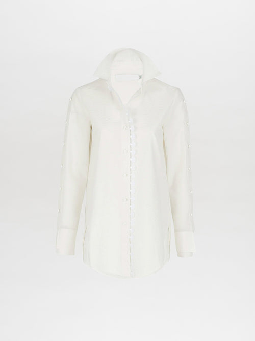 A Premium Blouse White with ruffles on the collar and cuffs, perfect for Spring 2023.