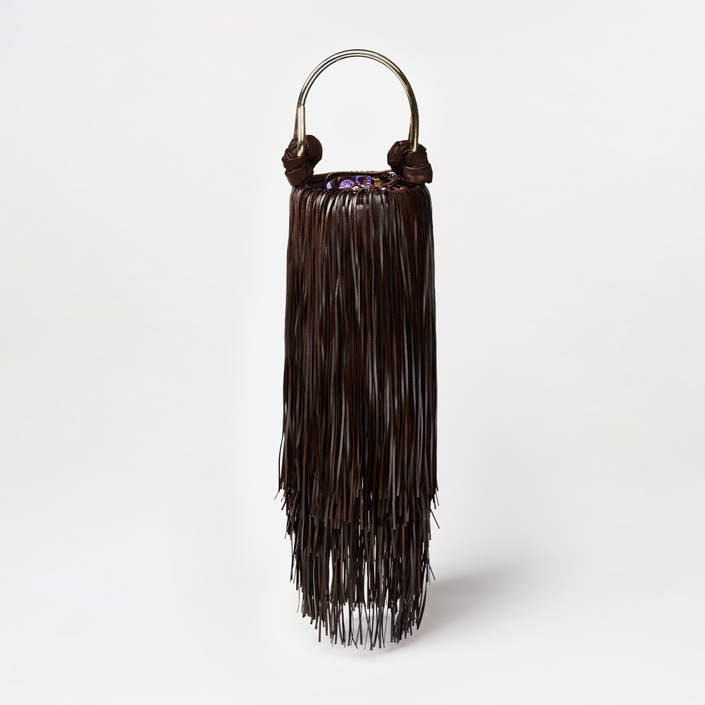 Brown fringe handbag with a metallic handle on a white background