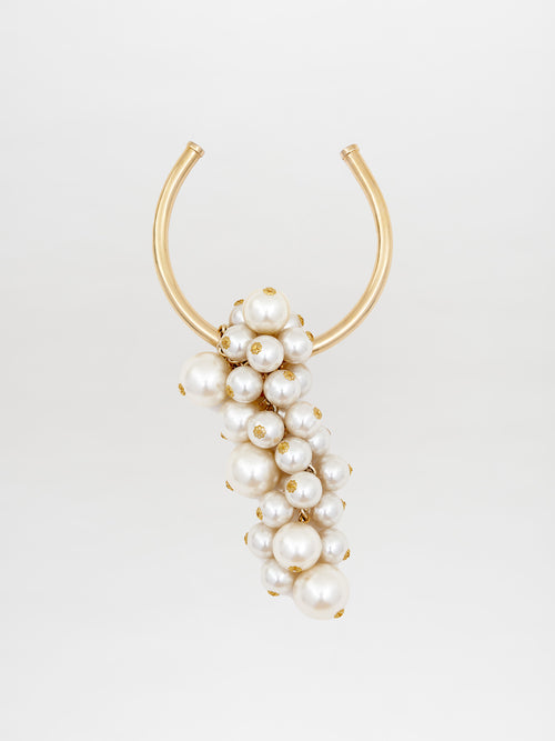 Introducing the Shania Necklace Pearl: a gold U-shaped necklace embellished with an array of white pearls in various sizes, elegantly draping in a cascading formation. Available for pre-order now to ensure delivery by February 15th.