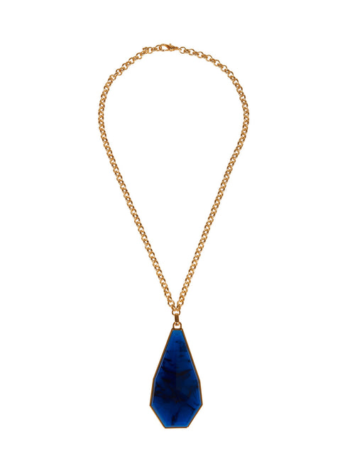 A Ascoli Necklace Navy with a blue stone on a gold chain is available to order.