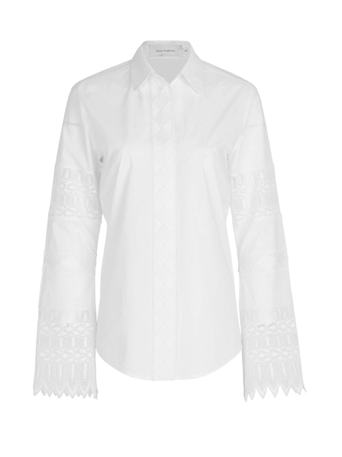 A Aspasia Blouse White with guipure lace detailing on the sleeves.