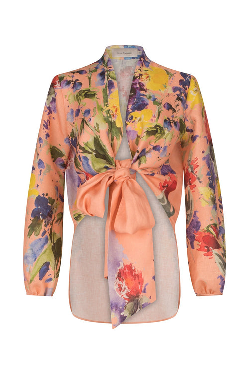 A Floral Blouse Apricot Spring Garden with a bow at the v neckline.