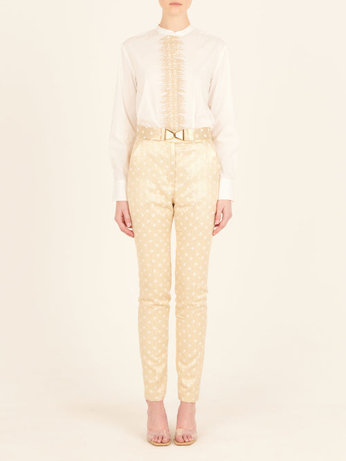 A pair of Orion Pant Gold Inverted with polka dots.