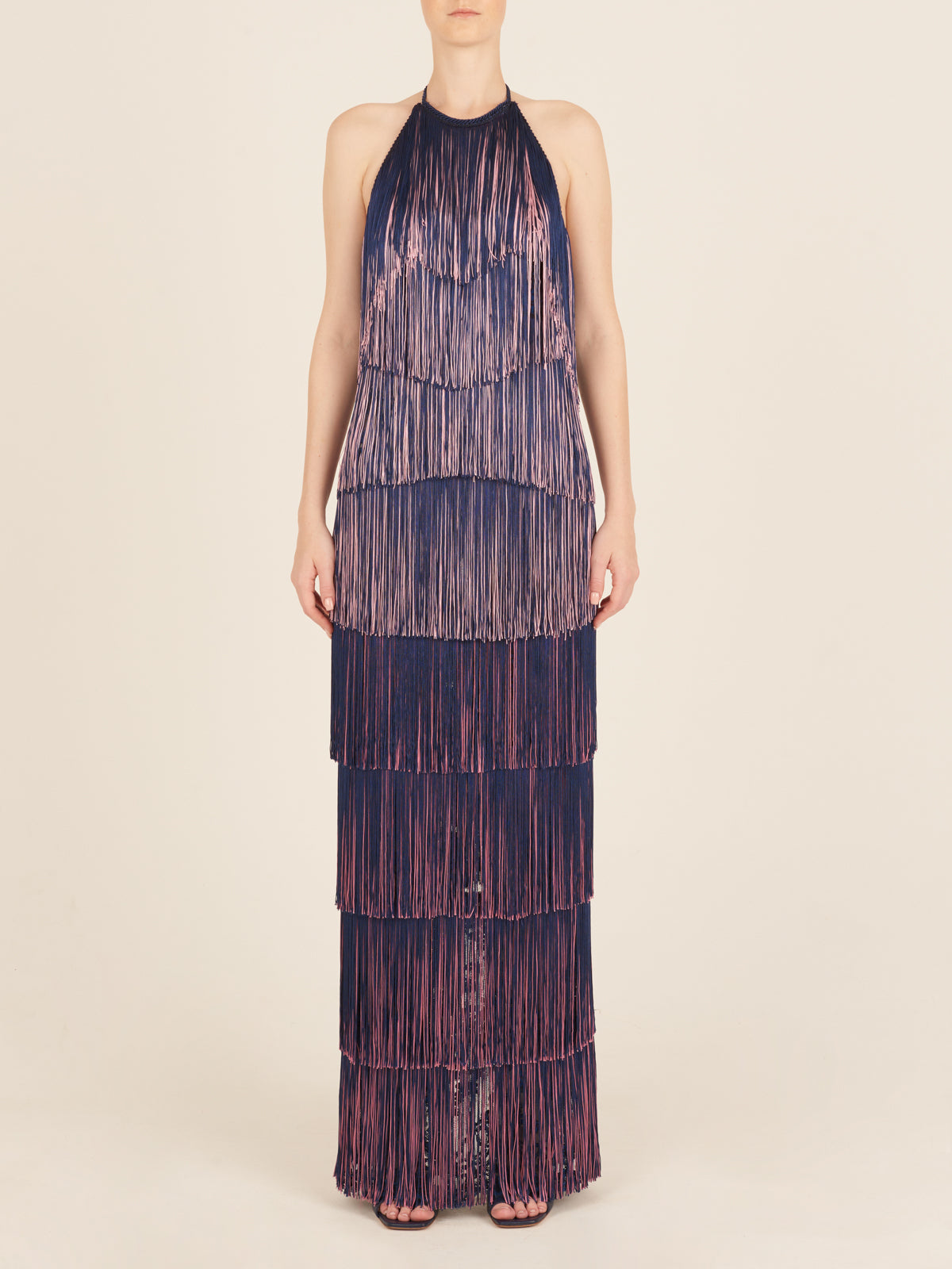 A floor-grazing fringed Paris Dress Navy with a touch of glamour in blue and pink hues.