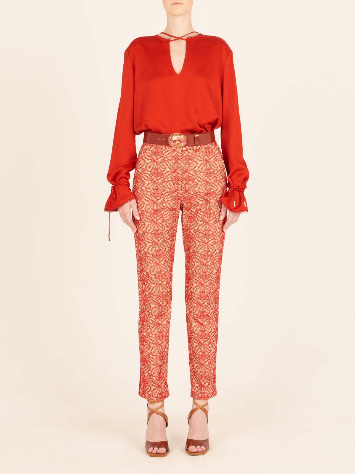 A figure-flattering Zafra Blouse Rouge with lace trim.