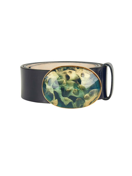 A Irene Belt Navy with a gold buckle adorned with a green stone.