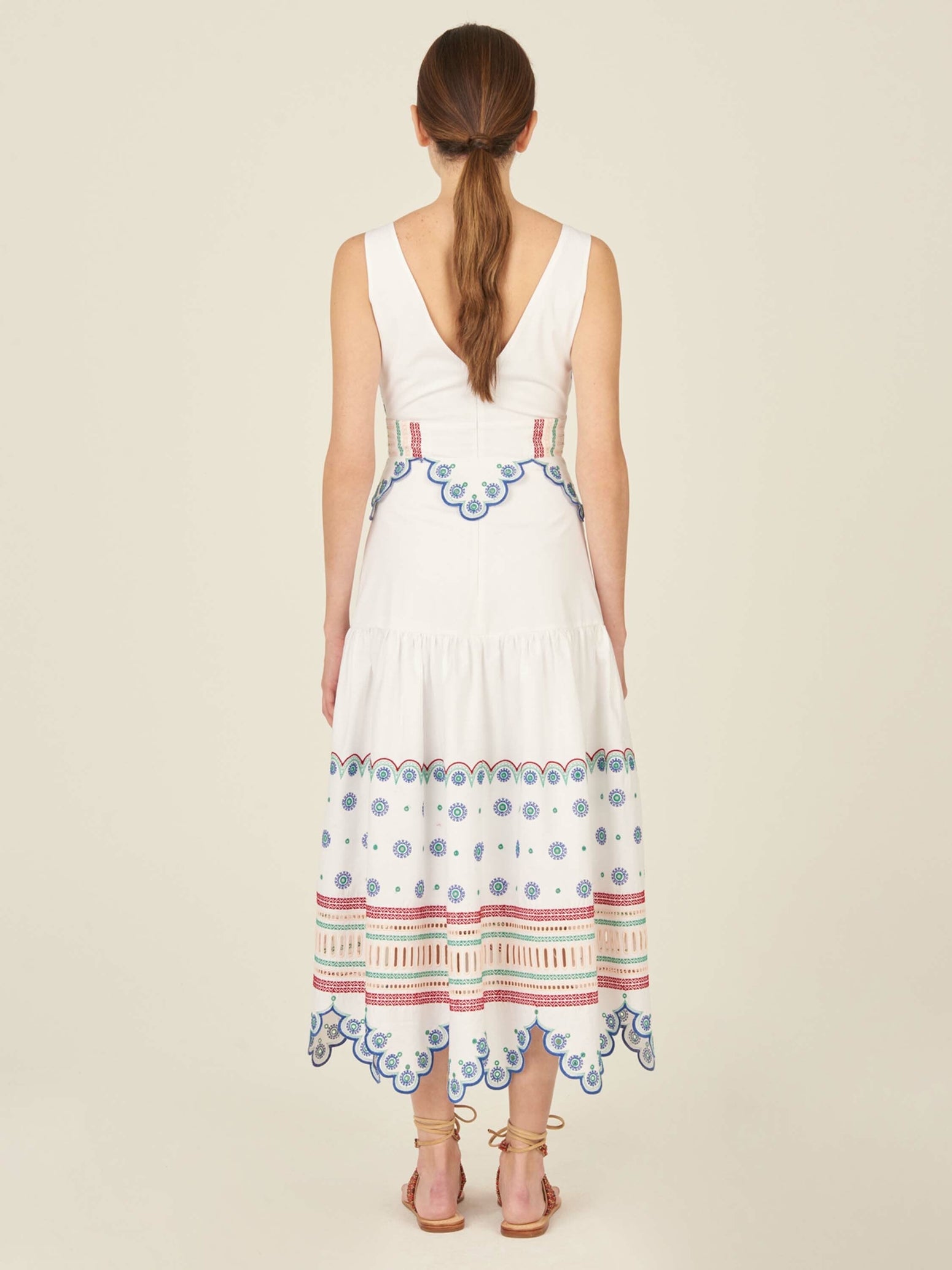 A Biset Dress White Blue with colorful embroidered details.