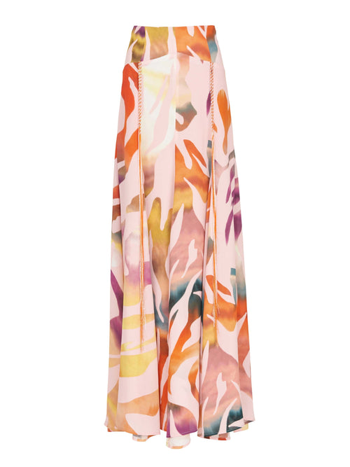 A long, colorful Iona Skirt Blush Prismatic with an abstract pattern in shades of orange, pink, and purple on a white background, made from soft viscose fabric.