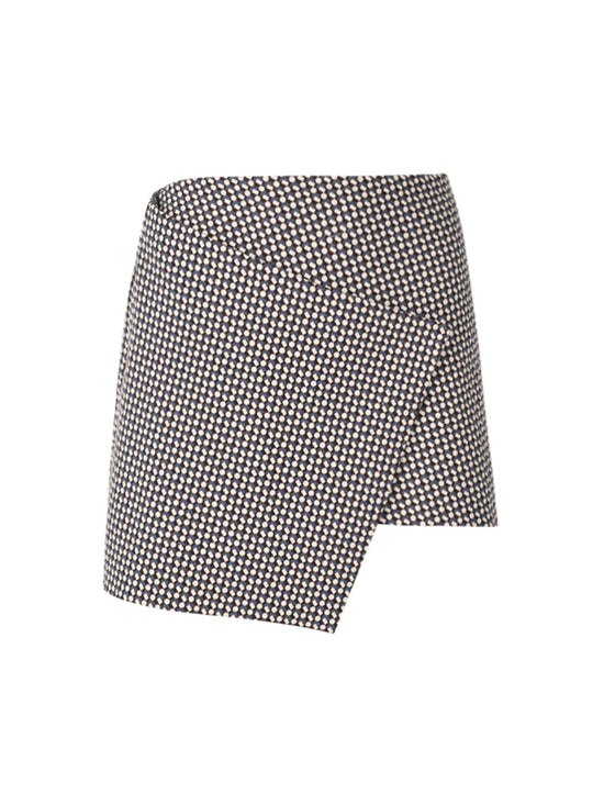 The Aime Skort Celeste Geometric Print features a black and white geometric pattern with a modern silhouette and an asymmetrical hem.