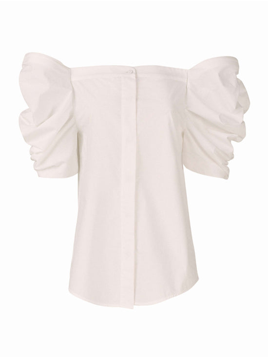 The Wynn Blouse White with voluminous puff sleeves and a central button closure on the front, crafted from lightweight cotton.