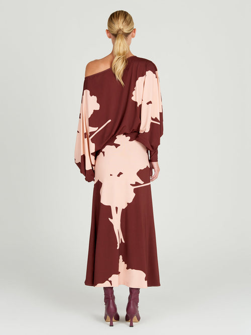 A Calta Dress Cacao Floral with batwing sleeves in a floral print.