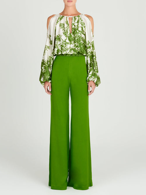 An Elke Blouse Green Cyprus in a nature-inspired print, with an adjustable fit.