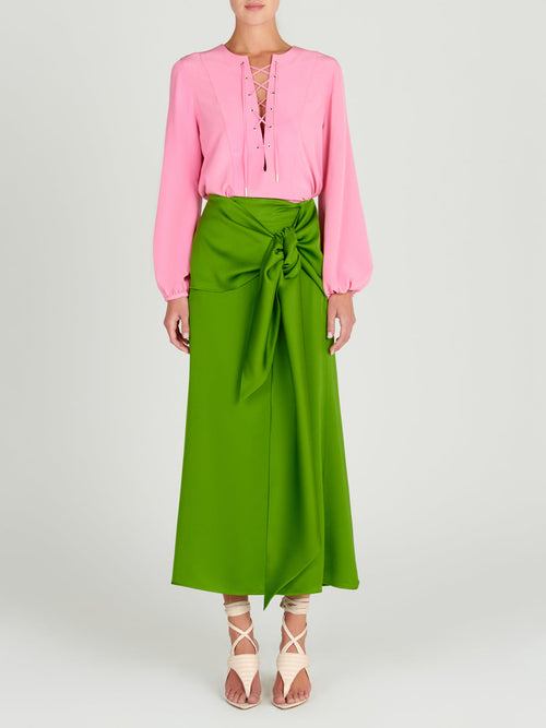 A Trento Skirt Lime with a bow, midi-length.