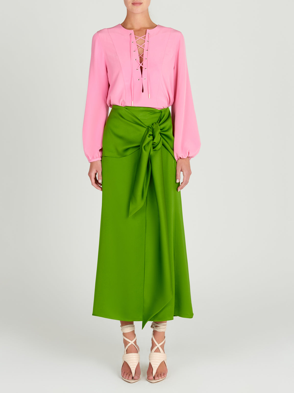 A Trento Skirt Lime with a bow, midi-length.