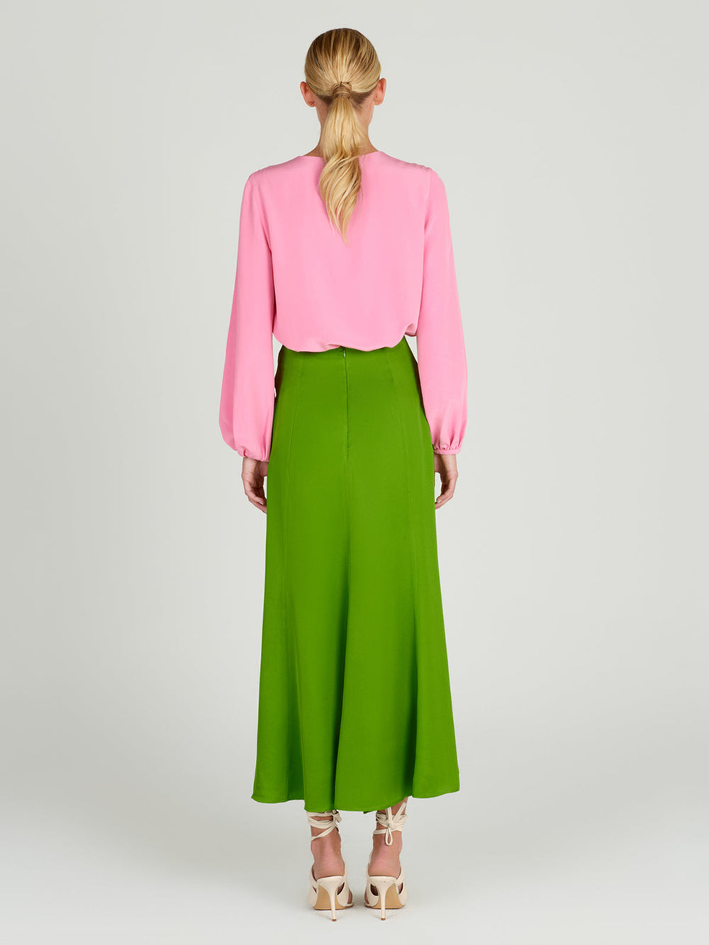 A Trento Skirt Lime with a bow, midi-length.