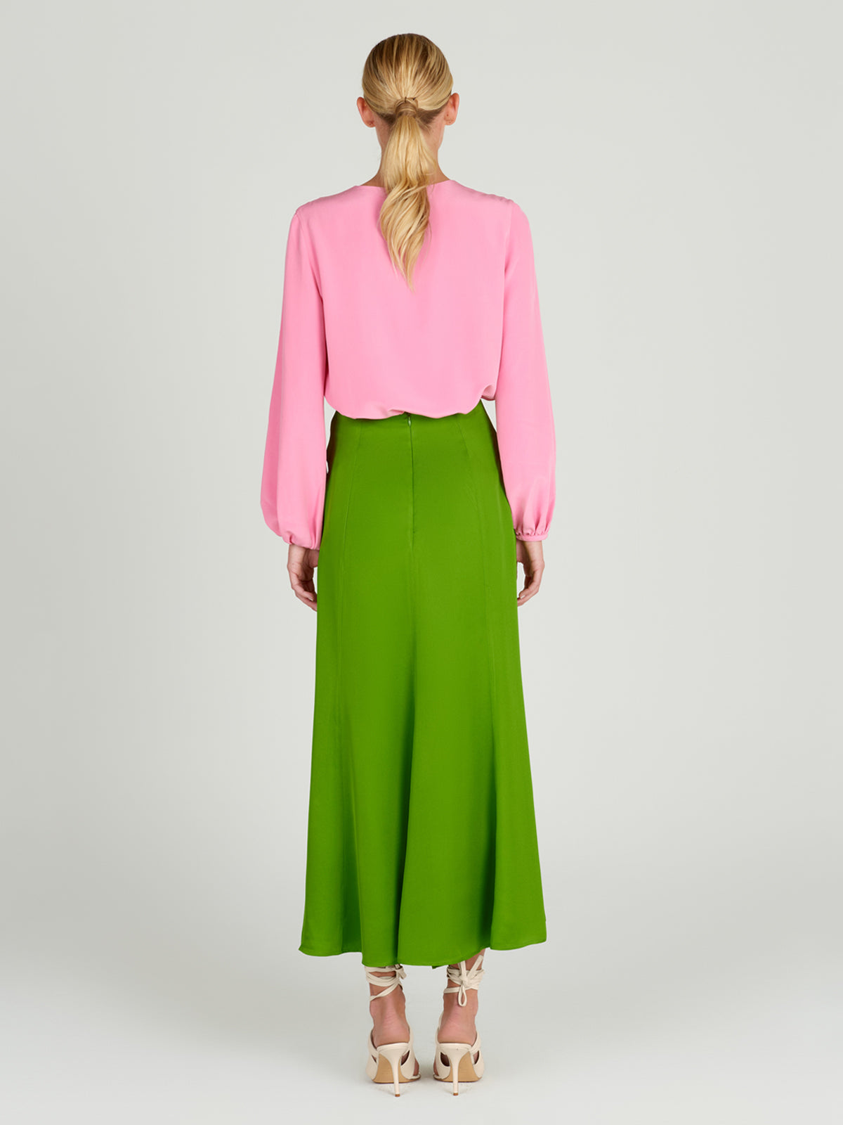 A Trento Skirt Lime with a bow, midi-length.