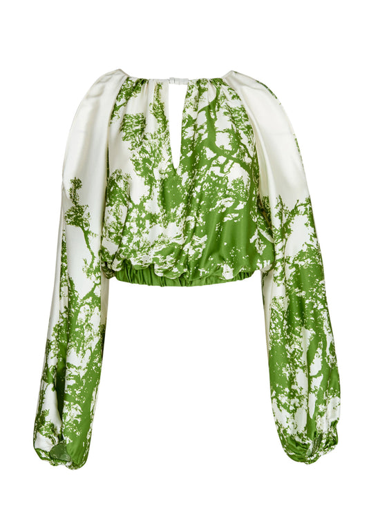 An Elke Blouse Green Cyprus in a nature-inspired print, with an adjustable fit.