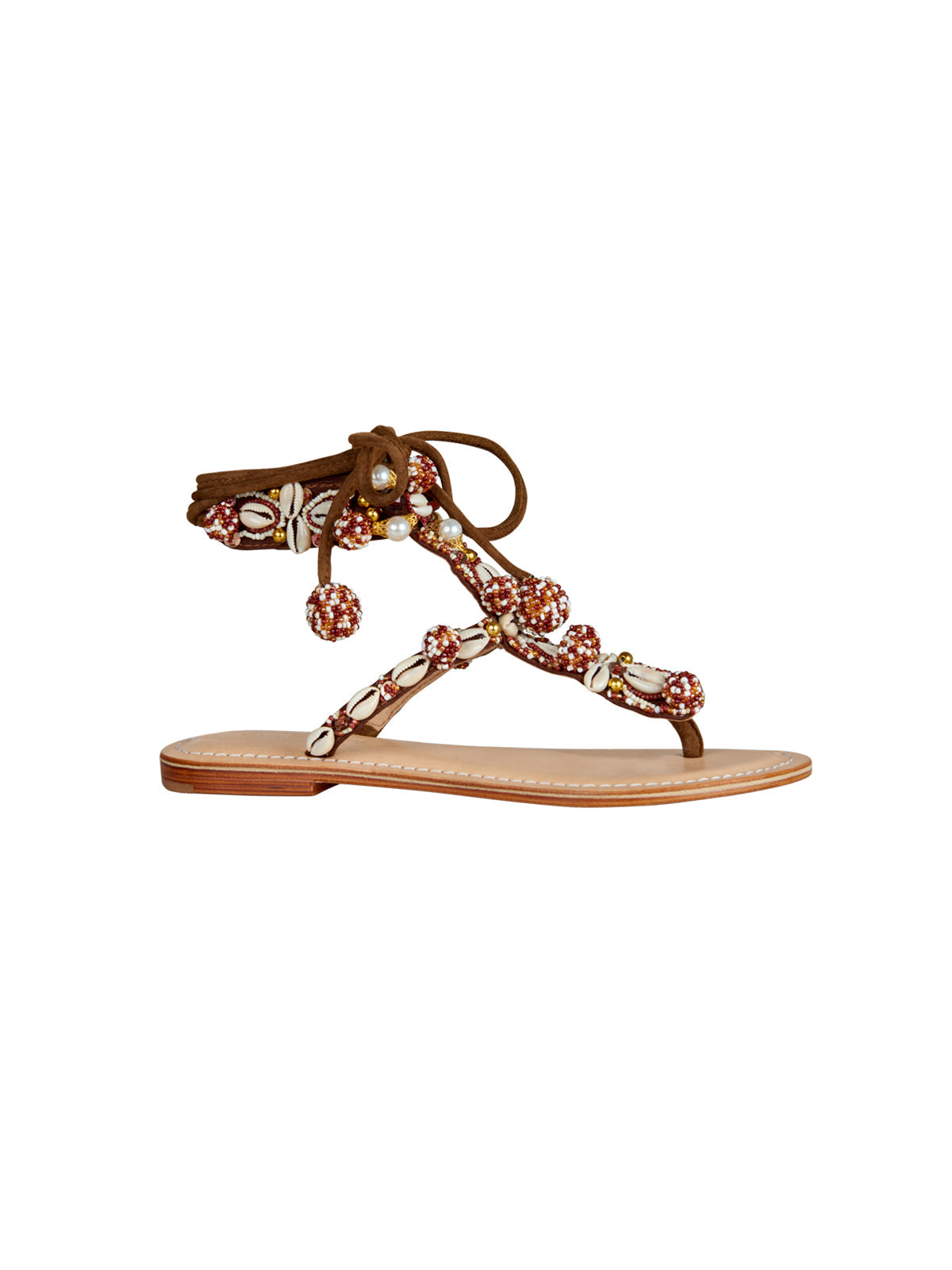 Tisha Sandals Cacao Red with ankle tie, decorated with beads, shells, and small pom-poms. Order now and we’ll ship in 1-3 days!