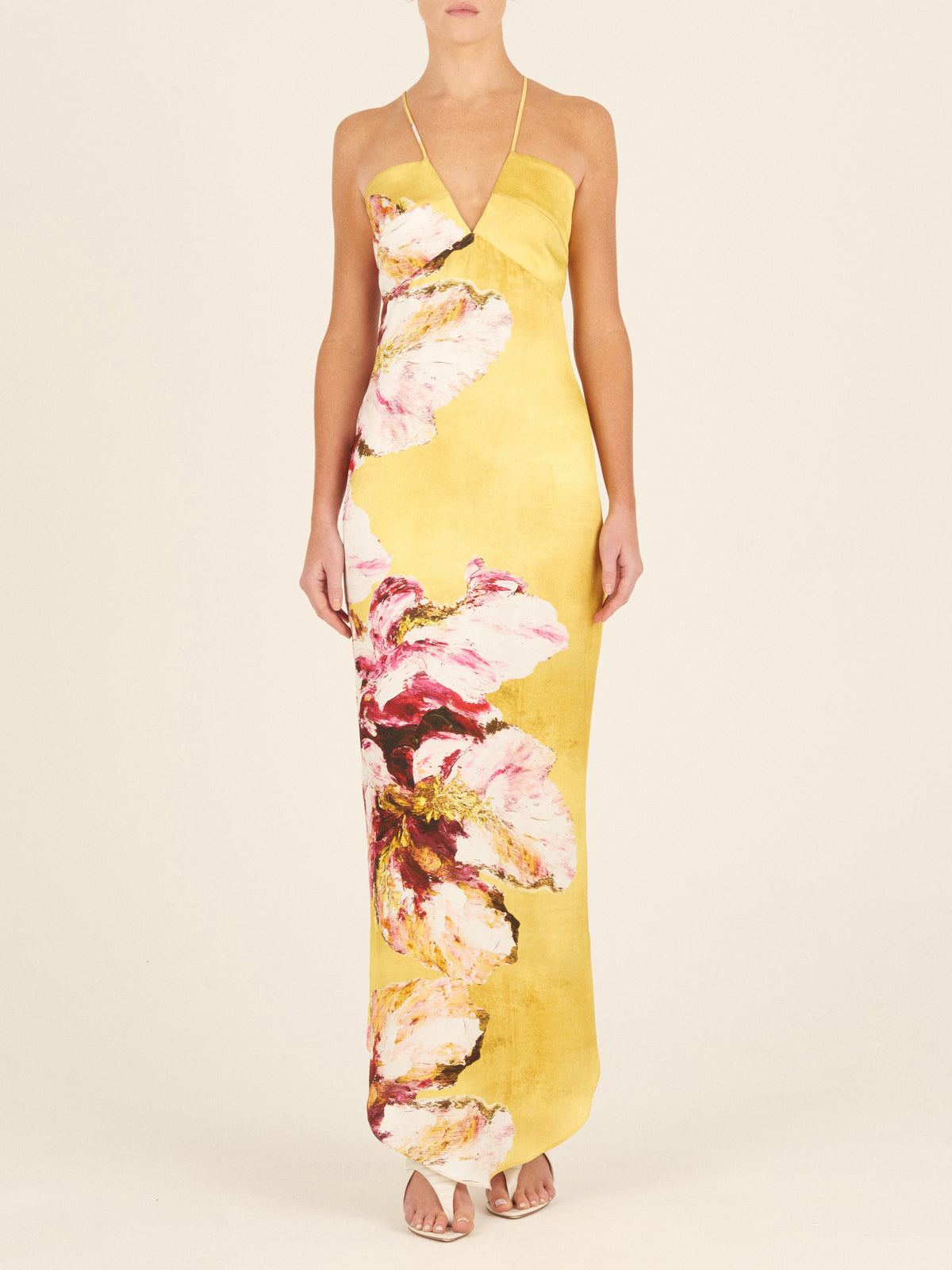 A yellow sleeveless Aisha Dress Canary Pink Flowers, with thin shoulder straps, isolated on a white background.