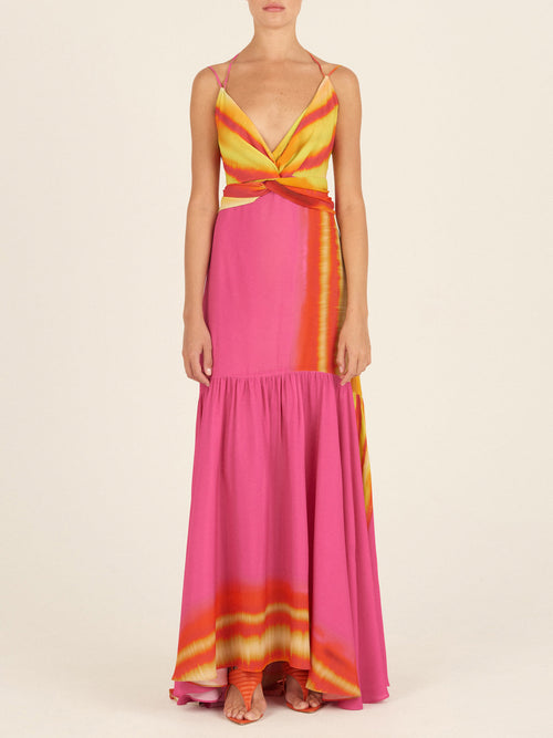 A woman wearing a colorful Eva Dress Fuchsia Lime Stripes for Spring 2023.