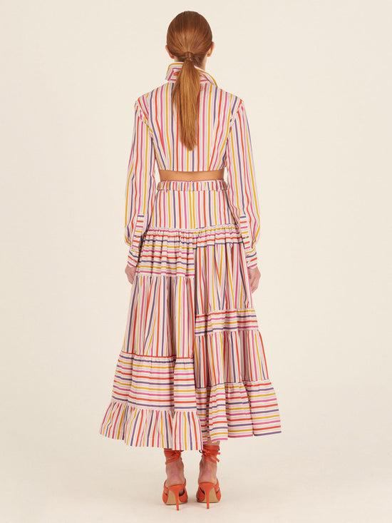 Marcel Blouse Golden Magenta Stripes in cropped style, featuring a twist front detail and multicolored gold magenta striped fabric, complete with buttoned cuffs.